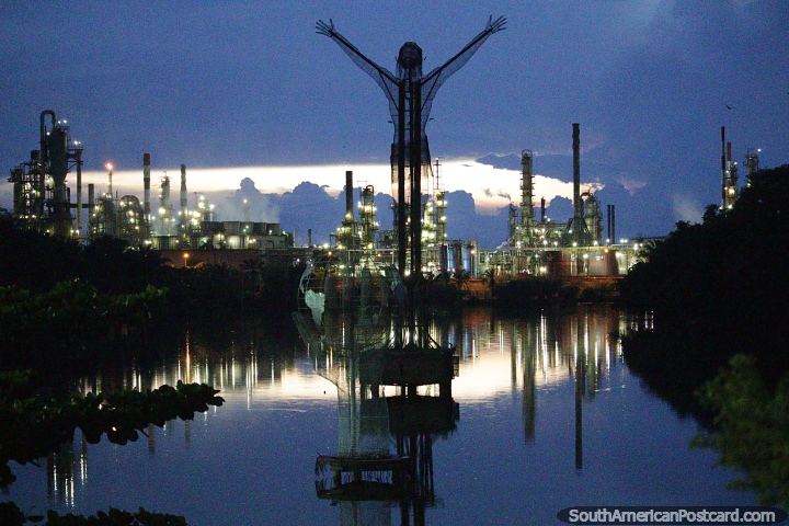 Cristo Petrolero, the petrol monument in Barrancabermeja at night with the petrol plant behind. (720x480px). Colombia, South America.
