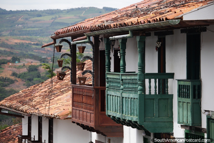 Large wooden balconies with decor overlooking the green hills and farmland around Barichara. (720x480px). Colombia, South America.