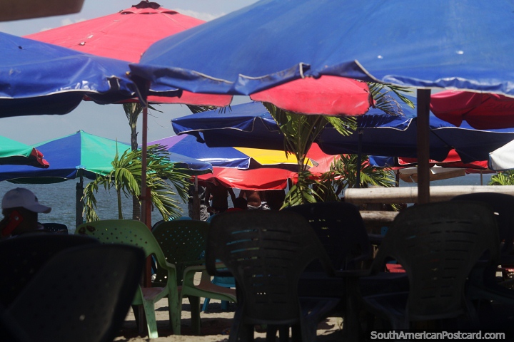 Relaxe em cadeiras sob guarda-sóis na praia do Morro, em Tumaco. (720x480px). Colômbia, América do Sul.