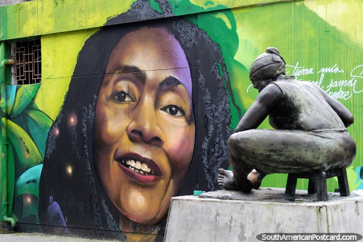 Street mural in Quibdo, a woman with  dreadlocks and a bronze monument to women. (720x480px). Colombia, South America.