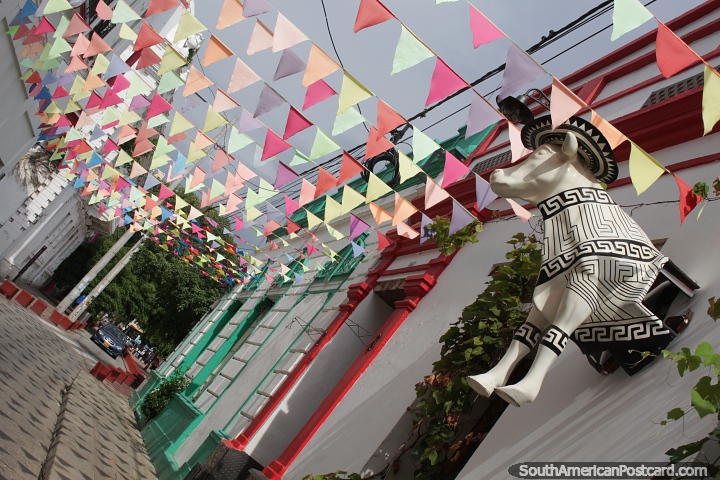 Colorful street and walkway with flags, a bull and nice facades in Santa Marta. (720x480px). Colombia, South America.