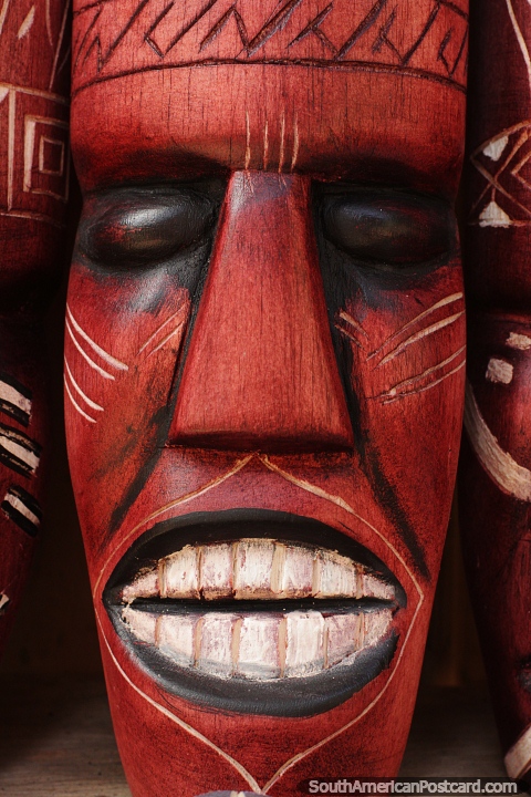 Cara de madera esculpida con boca y dientes grandes, museo Mocagua cerca de Leticia. (480x720px). Colombia, Sudamerica.