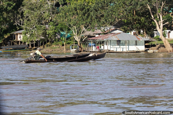 Homem em uma canoa fluvial dirige-se para a costa na Amaznia em torno de Leticia. (720x480px). Colmbia, Amrica do Sul.