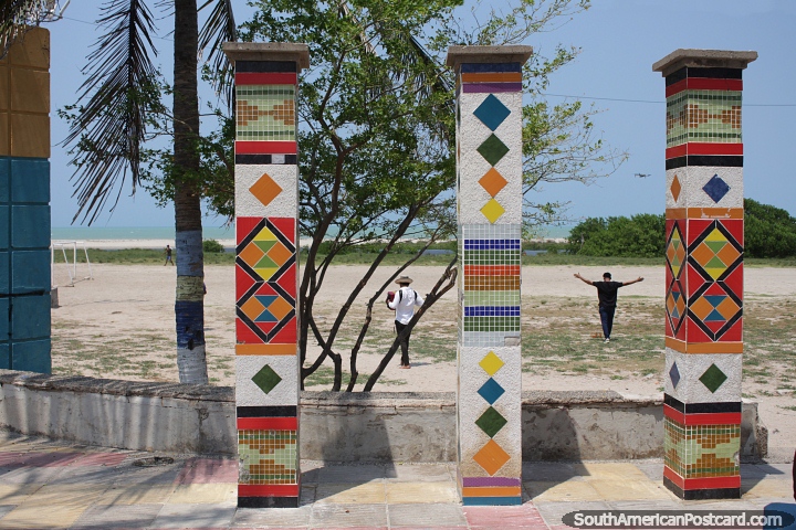 Tiled columns artwork in front of the beach and ocean in Riohacha. (720x480px). Colombia, South America.