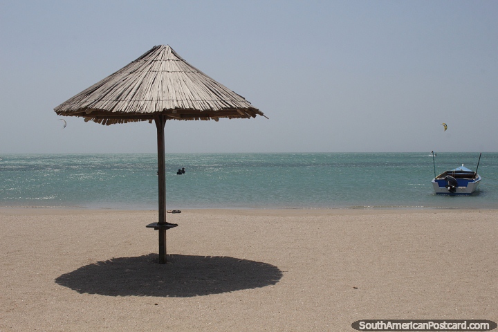 Beachfront in Cabo de la Vela with sand, sea and a thatched umbrella. (720x480px). Colombia, South America.