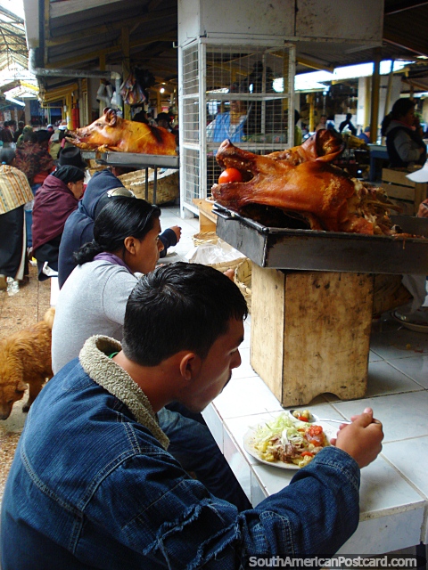 The Otavalo food market has freshly made pork meals to eat. (480x640px). Ecuador, South America.