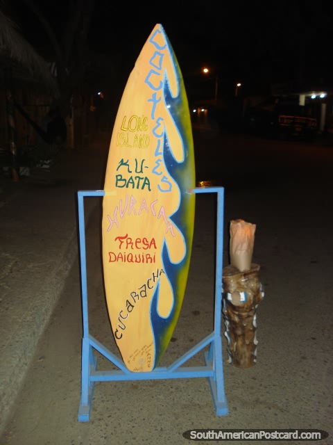 Surfboard sits on the main street of Puerto Lopez outside a cabana. (480x640px). Ecuador, South America.