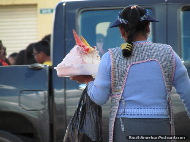 Woman carries tub of ice-cream and cones to sell in Quito streets. (640x480px). Ecuador, South America.