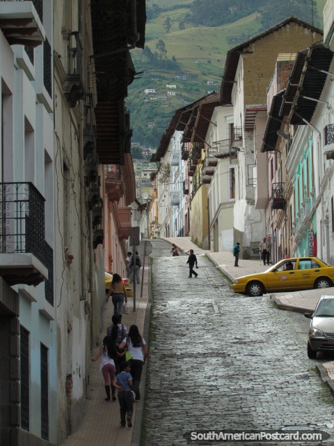 Cobblestone street and old houses in Quito historical center. (480x640px). Ecuador, South America.