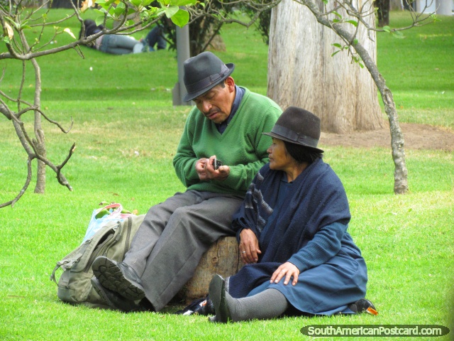 Man and woman sit on grass in park La Alameda in Quito. (640x480px). Ecuador, South America.