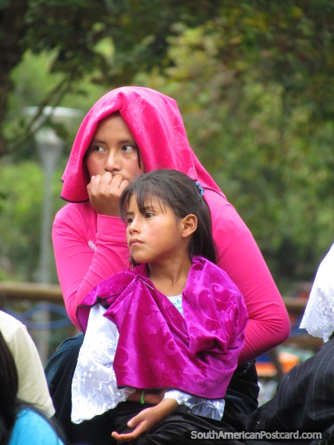 Local woman and girl of Quito in purple and pink in park El Ejido. (480x640px). Ecuador, South America.