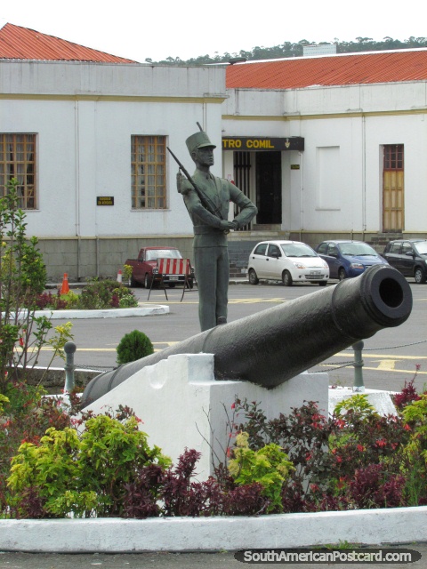 Big black cannon and statue guard at military college in Quito. (480x640px). Ecuador, South America.