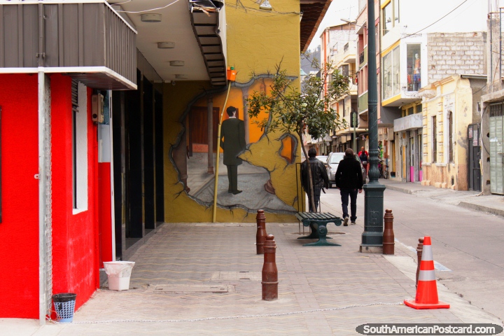 Man in a suit, wall mural in Ambato, 2 men walk past. (720x480px). Ecuador, South America.