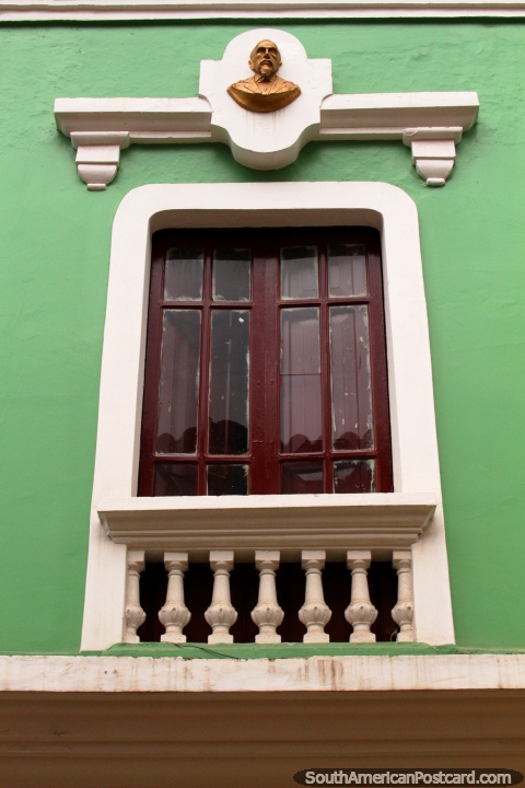 Window with gold bust at the top in Guaranda. (480x720px). Ecuador, South America.