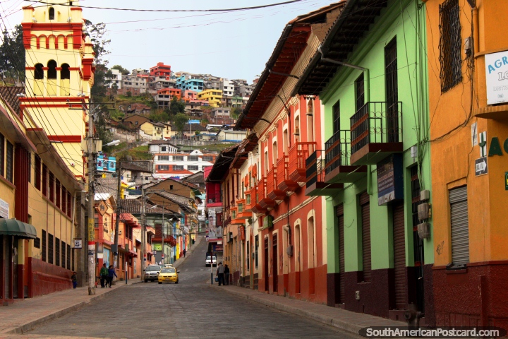 A colorful street in Guaranda with houses and a church with houses on the hills in the distance. (720x480px). Ecuador, South America.