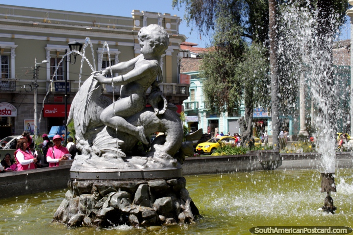 Crazy baby rides a fish at the Neptune Fountain at Parque Sucre in Riobamba. (720x480px). Ecuador, South America.