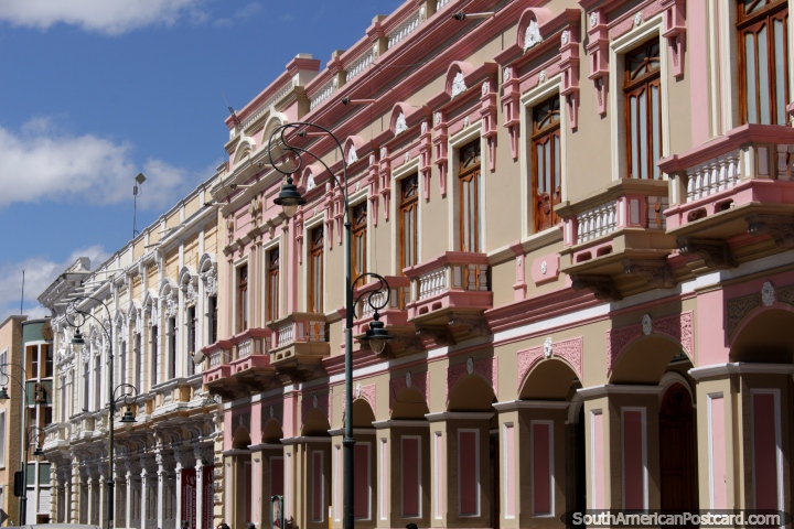 Pink and white historic buildings with well-kept facades beside Parque Sucre in Riobamba. (720x480px). Ecuador, South America.