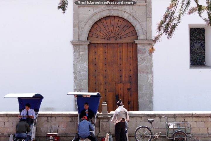 Men have their shoes shined outside the cathedral in Riobamba. (720x480px). Ecuador, South America.