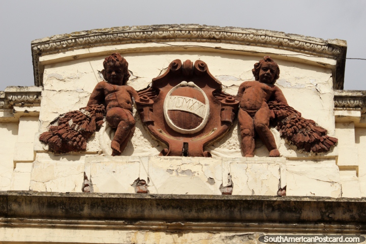 2 angels at the top of a building facade in Riobamba, brown in color. (720x480px). Ecuador, South America.