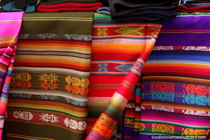 Colored material for sale at Plaza Roja in Riobamba, brown, red and purple. (720x480px). Ecuador, South America.