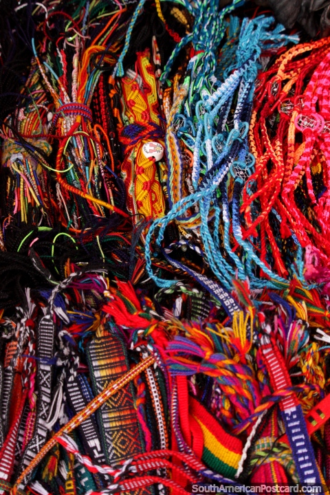 Wrist-bands and stringy things for sale at Plaza Roja in Riobamba. (480x720px). Ecuador, South America.