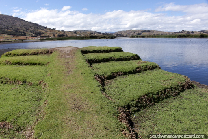 View of the lagoon at Colta from the end of the grass pathway. (720x480px). Ecuador, South America.