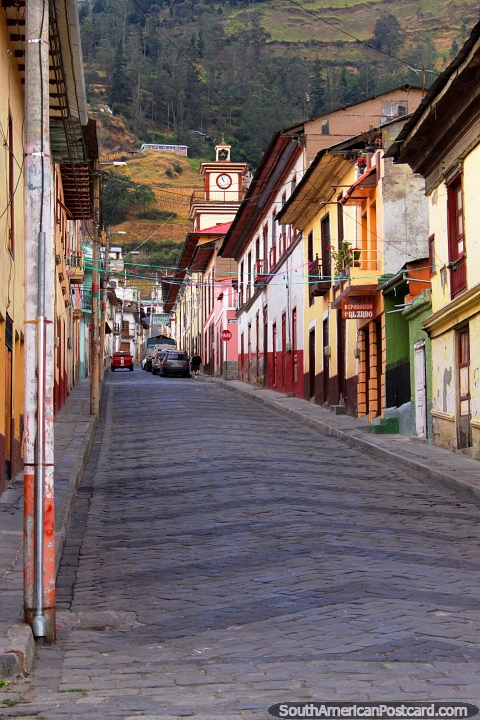 View up a street to the church clock tower in Alausi. (480x720px). Ecuador, South America.