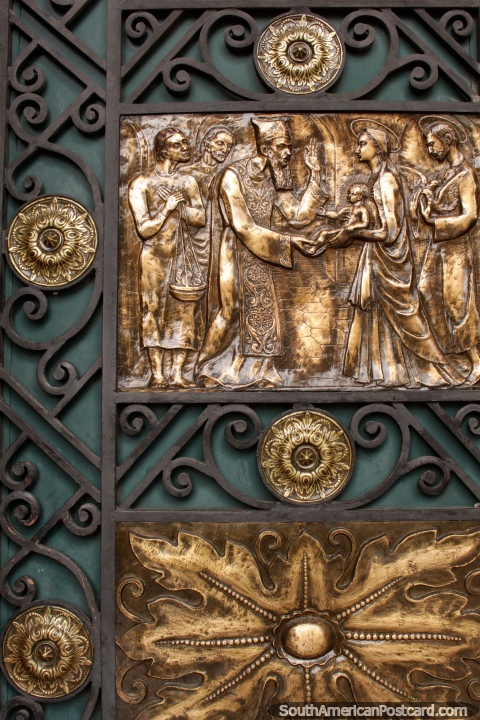 Gold plated cathedral doors with sculptured designs in Cuenca. (480x720px). Ecuador, South America.