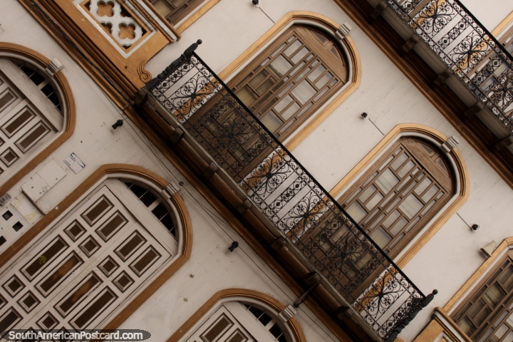 Iron balcony and gold-framed doors and windows, nice facade in Cuenca. (720x480px). Ecuador, South America.