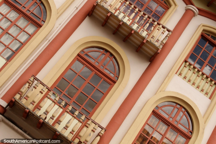 Balconies of wood and a nice facade with arched windows in Cuenca. (720x480px). Ecuador, South America.