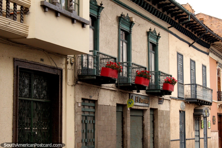 Flores rojas a lo largo de los balcones de hierro, bonitas fachadas en Cuenca. (720x480px). Ecuador, Sudamerica.