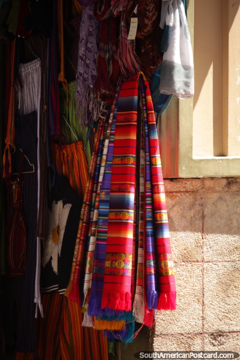 Shawls in indigenous colors for sale in central Cuenca. (480x720px). Ecuador, South America.