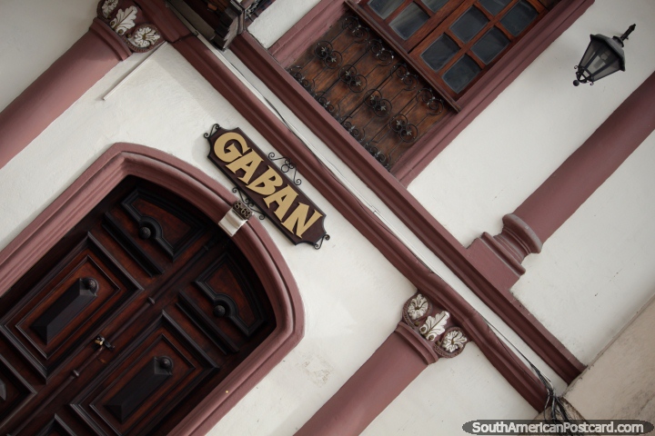 Dark wooden door and window, facade with columns and lamps in Cuenca, Gaban. (720x480px). Ecuador, South America.