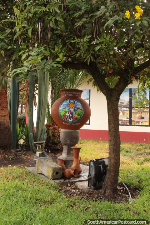 A painted ceramic pot in a garden under a tree in Pujili. (480x720px). Ecuador, South America.