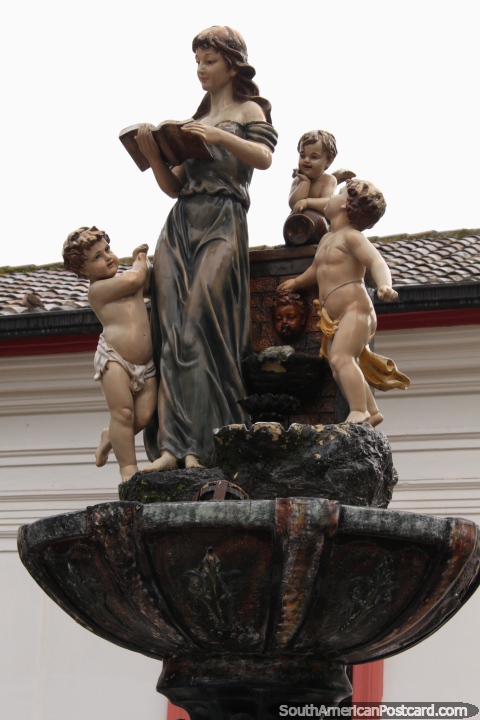 A fountain feature with 4 figures outside the government building in Pujili. (480x720px). Ecuador, South America.