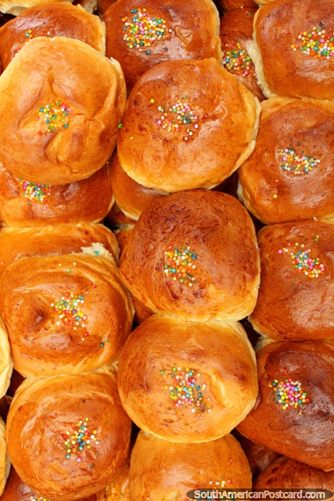 Sweet bread buns with colored sprinkles, for sale at Plaza Kennedy, Saquisili. (480x720px). Ecuador, South America.