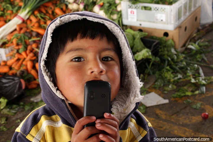 O pequeno rapaz pede uma foto no mercado de Saquisili. (720x480px). Equador, América do Sul.