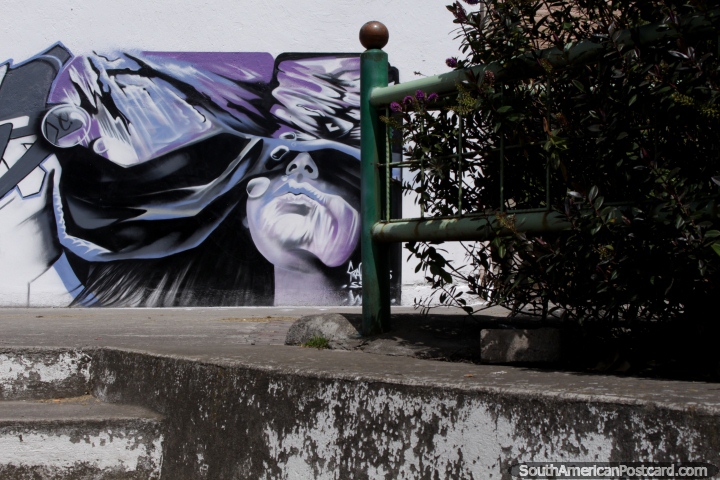 Purple mural with purple flowers beside in Machachi. (720x480px). Ecuador, South America.