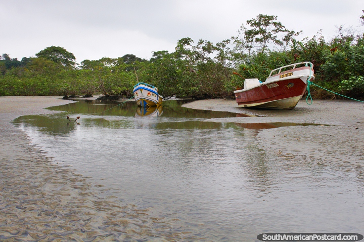 An inlet and a pair of boats on a grey day in Mompiche. (720x480px). Ecuador, South America.