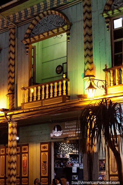 Arts and souvenirs shop on ground level of this classic building in Zaruma at night. (480x720px). Ecuador, South America.