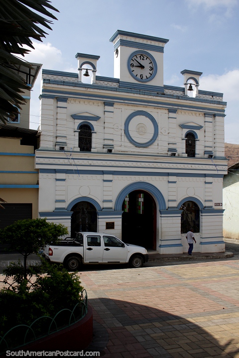 White church with 2 bells and a clock in Portovelo, town close to Zaruma. (480x720px). Ecuador, South America.