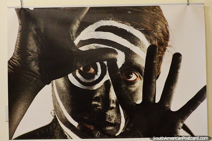 Black man with white paint on his face and fingers spread, photo in the cultural center in Loja. (720x480px). Ecuador, South America.
