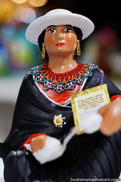 Woman in traditional clothing, arts and crafts at Almacen Artesanal Municipal, Loja. (480x720px). Ecuador, South America.