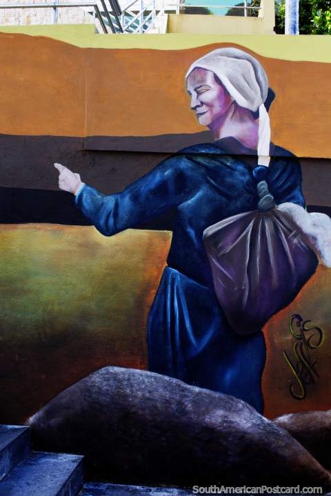 Woman in blue with headscarf and bag over her shoulder, street art in Zamora. (480x720px). Ecuador, South America.
