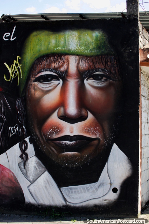 Indigenous man with whiskers and green head wear, street art in Zamora. (480x720px). Ecuador, South America.