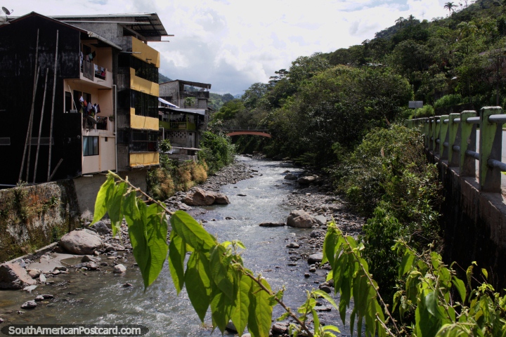 The river runs between the main road and the town in Limon in the Oriente. (720x480px). Ecuador, South America.