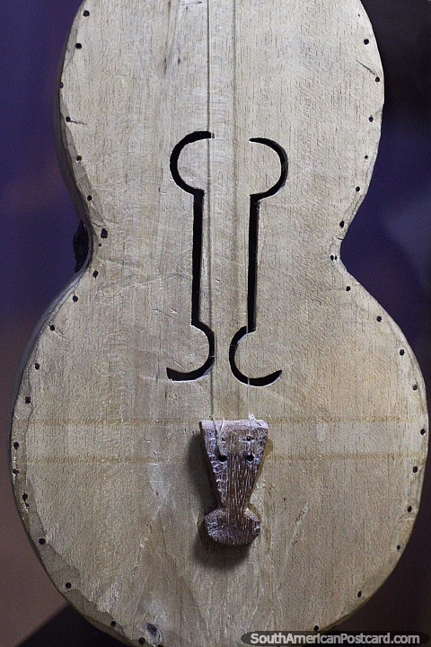 Ancient wooden violin made in the jungle by the indigenous, Archaeological museum, Puyo. (480x720px). Ecuador, South America.