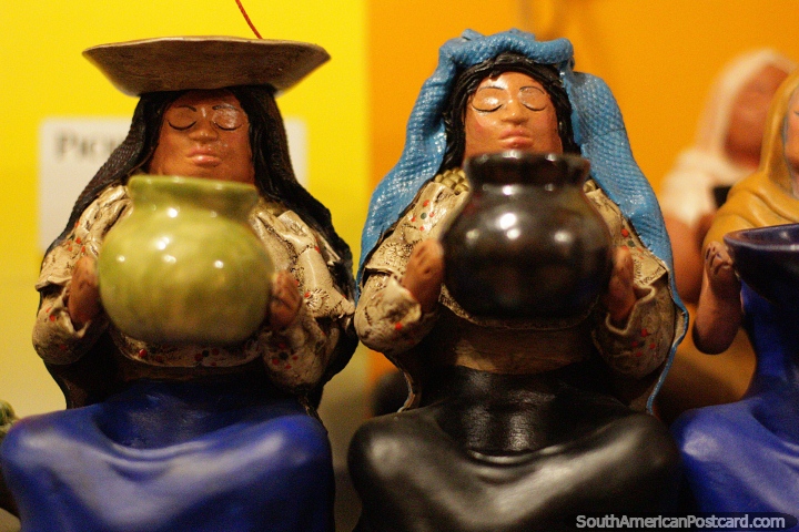 Ceramic women holding pots, high quality crafts in Banos. (720x480px). Ecuador, South America.