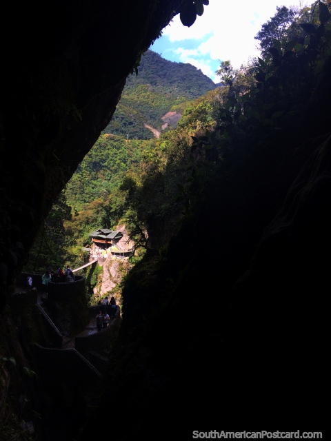 View from darkness to the Colgante Bridge and viewpoint at Pailon del Diablo waterfall, Banos. (480x640px). Ecuador, South America.