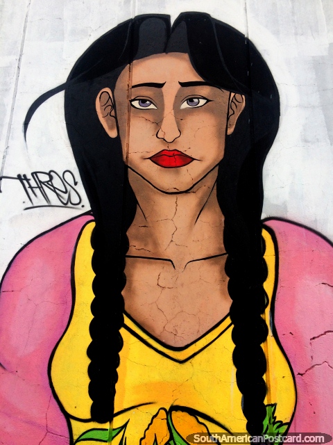 Street art in Latacunga in the park below the bridge, woman in yellow and pink with long hair. (480x640px). Ecuador, South America.